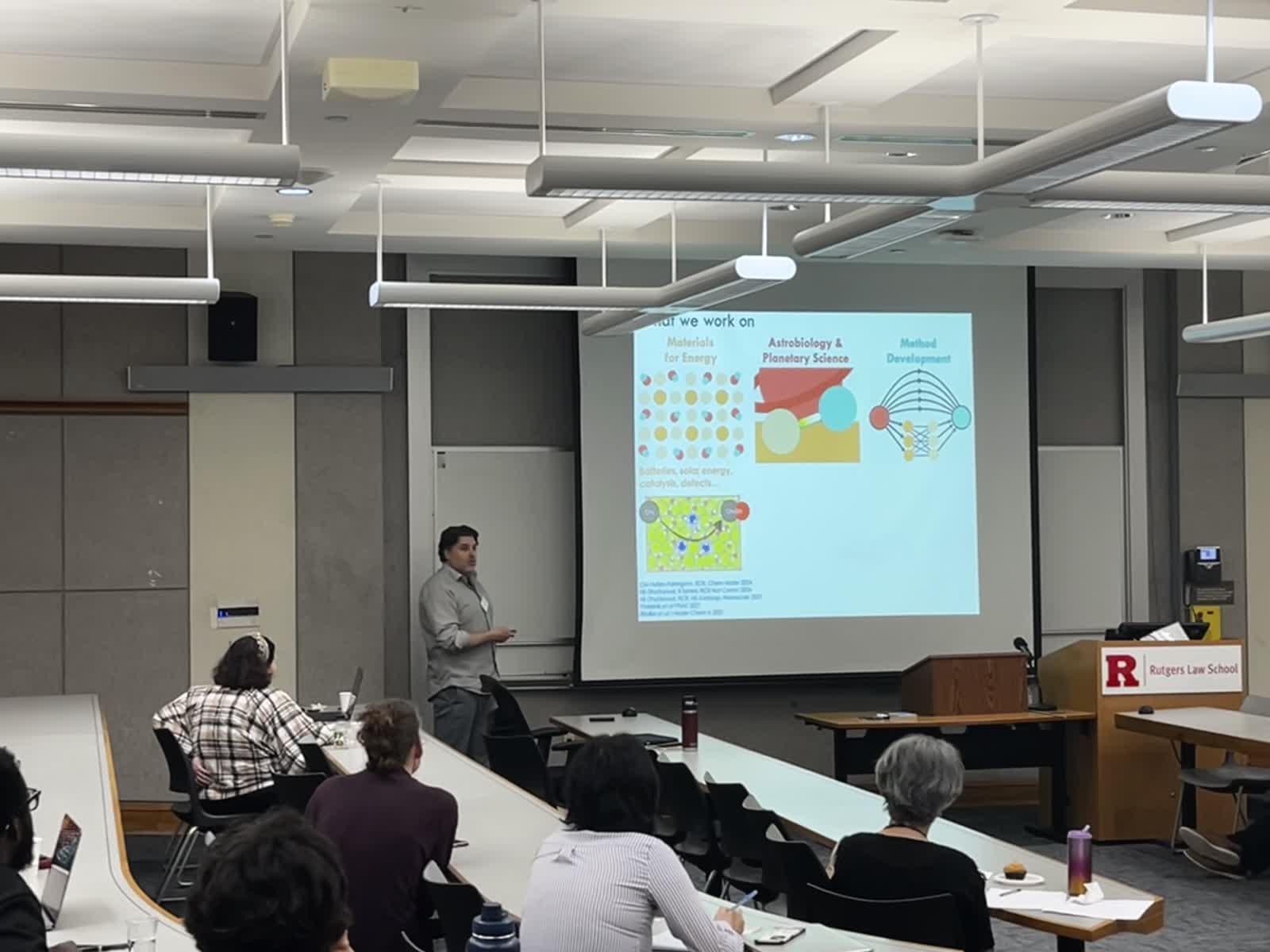 Speaker and projected slide during the symposium