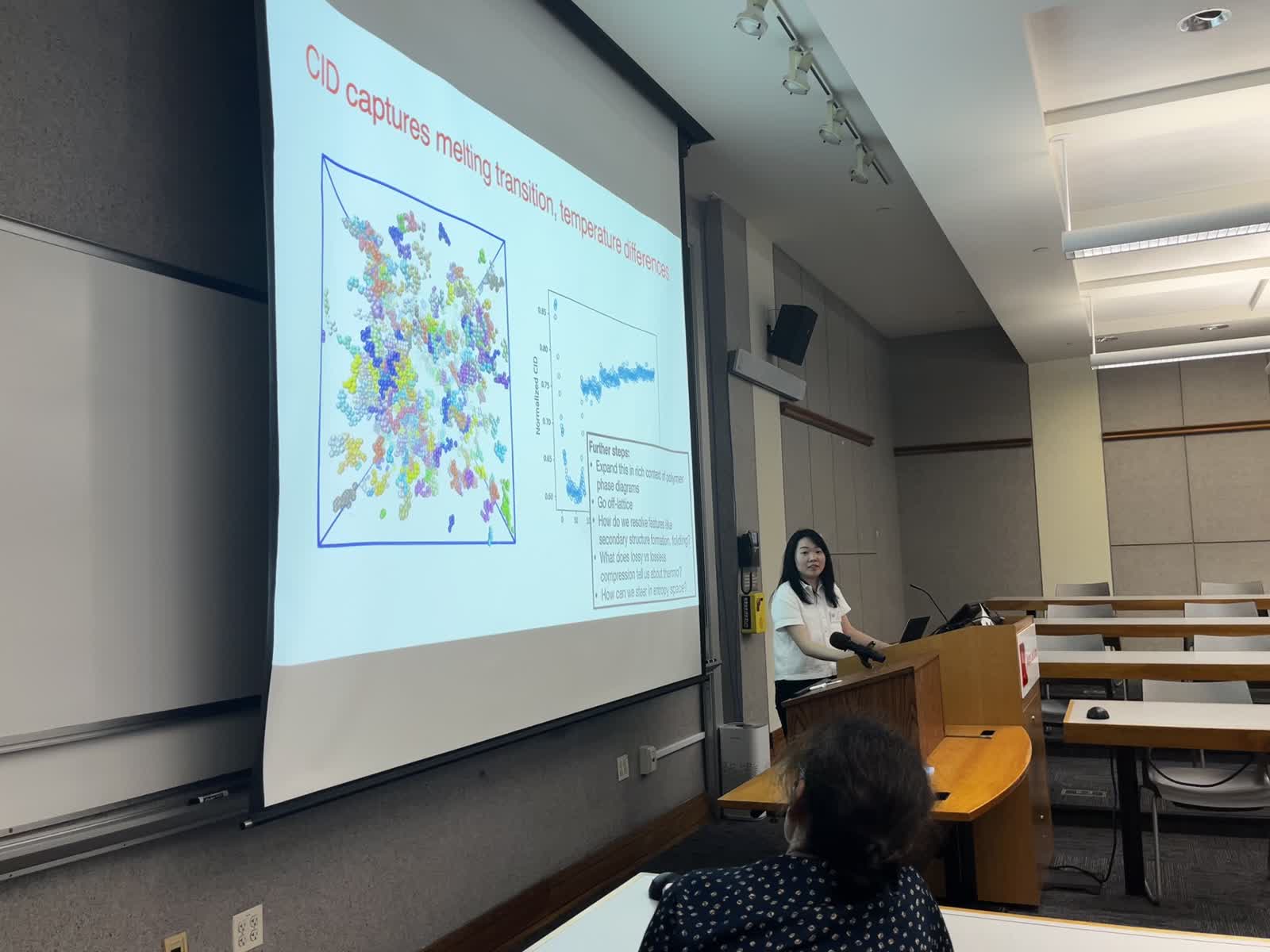 Speaker presenting a slide at the end of the symposium